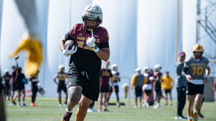 Tight end AJ Ia (14) works out at Sun Devils spring football practice at ASU's Kajikawa practice fields on March 27, 2025, in Tempe, Ariz.