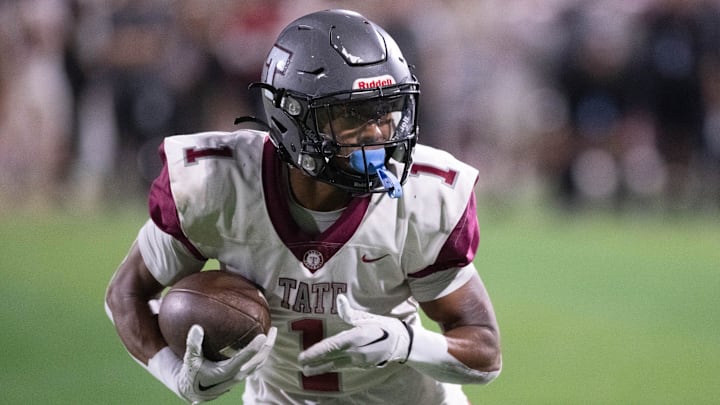 Christian Neptune (1) carries the ball as the Tate High School Aggies take on the Booker T. Washington High School Wildcats in the inaugural First City Bowl football game at Blue Wahoos Stadium in Pensacola on Friday, Nov. 3, 2023. Christian Neptune (1) carries the ball as the Tate High School Aggies take on the Booker T. Washington High School Wildcats in the inaugural First City Bowl football game at Blue Wahoos Stadium in Pensacola on Friday, Nov. 3, 2023.