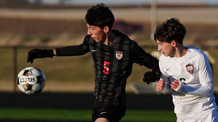 Gilbert William Youngberg (5) drives with the ball around Ames mid-fielder Gavin Murphy (6) during the first half in the high school boys soccer at Gilbert High School on March 27, 2026, in Gilbert, Iowa.