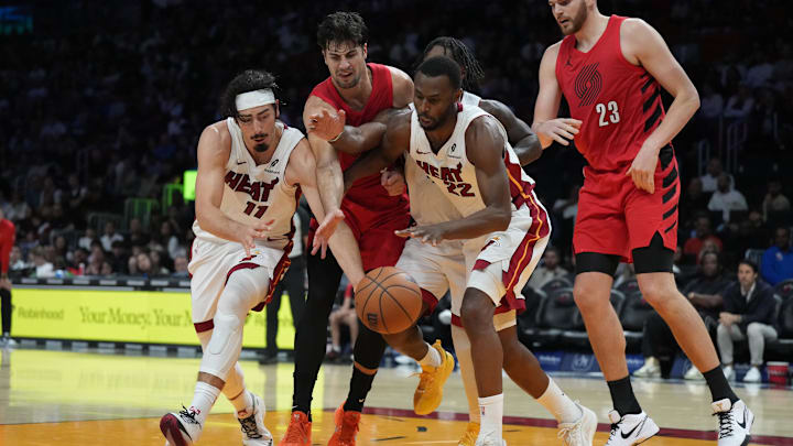 Nov 8, 2025; Miami, Florida, USA;  Miami Heat forward Jaime Jaquez Jr. (11) and forward Andrew Wiggins (22) battle for possession with Portland Trail Blazers forward Deni Avdija (8) as center Donovan Clingan (23) looks on during the second half at Kaseya Center. Mandatory Credit: Jim Rassol-Imagn Images