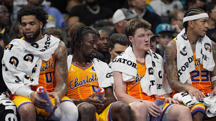 Nov 15, 2025; Charlotte, North Carolina, USA; Charlotte Hornets forward Miles Bridges (0), guard Sion James (4), guard Kon Knueppel (7) and guard Tre Mann (23) at the end of the game on the bench showing fatigue  during the second half against the Oklahoma City Thunder at Spectrum Center. Mandatory Credit: Jim Dedmon-Imagn Images