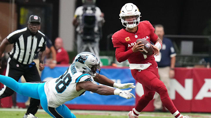 Arizona Cardinals quarterback Kyler Murray (1) scrambles away from Carolina Panthers linebacker D.J. Wonnum (98) at State Farm Stadium on Sept 14, 2025. Arizona Cardinals quarterback Kyler Murray (1) scrambles away from Carolina Panthers linebacker D.J. Wonnum (98) at State Farm Stadium on Sept 14, 2025.