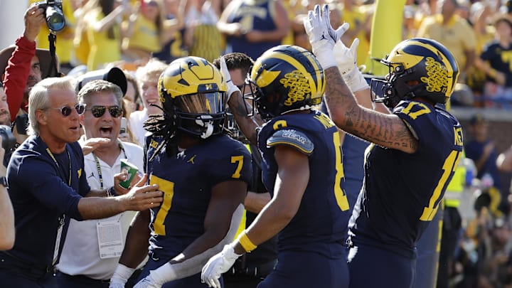 Sep 21, 2024; Ann Arbor, Michigan, USA;  Michigan Wolverines running back Donovan Edwards (7) receives congratulations from teammates after he rushes for a touchdown in the first half against the USC Trojans at Michigan Stadium. Mandatory Credit: Rick Osentoski-Imagn Images
