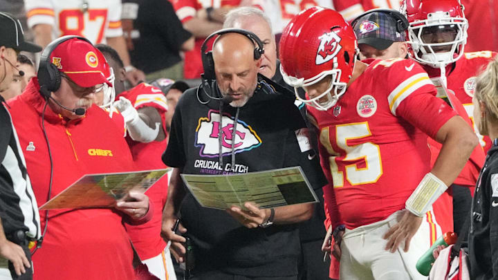 Oct 7, 2024; Kansas City, Missouri, USA; Kansas City Chiefs quarterback Patrick Mahomes (15) looks at plays with offensive coordinator Matt Nagy, center, and head coach Andy Reid against the New Orleans Saints during the first half at GEHA Field at Arrowhead Stadium. Mandatory Credit: Denny Medley-Imagn Images