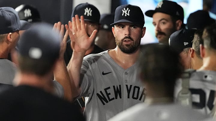 Apr 18, 2025; Tampa, Florida, USA; New York Yankees starting pitcher Carlos Rodon (55) is congratulated in the dugout after getting out of the sixth inning against the Tampa Bay Rays at George M. Steinbrenner Field.