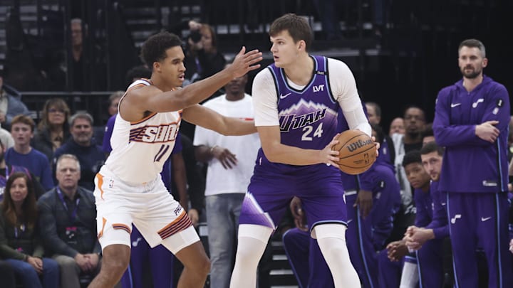 Oct 27, 2025; Salt Lake City, Utah, USA; Utah Jazz center Walker Kessler (24) looks to pass against Phoenix Suns forward Oso Ighodaro (11) during the first quarter at Delta Center. Mandatory Credit: Rob Gray-Imagn Images