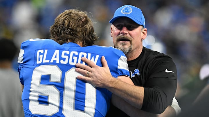 Dec 5, 2024; Detroit, Michigan, USA; Detroit Lions head coach Dan Campbell greets guard Graham Glasgow (60) during pregame warmups before their game against the Green Bay Packers at Ford Field. Mandatory Credit: Lon Horwedel-Imagn Images