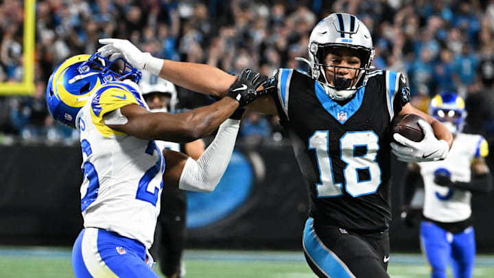 Jan 10, 2026; Charlotte, NC, USA; Carolina Panthers wide receiver Jalen Coker (18) makes a catch against Los Angeles Rams safety Kamren Kinchens (26) in the second half during the NFC Wild Card Round game at Bank of America Stadium. Mandatory Credit: Bob Donnan-Imagn Images
