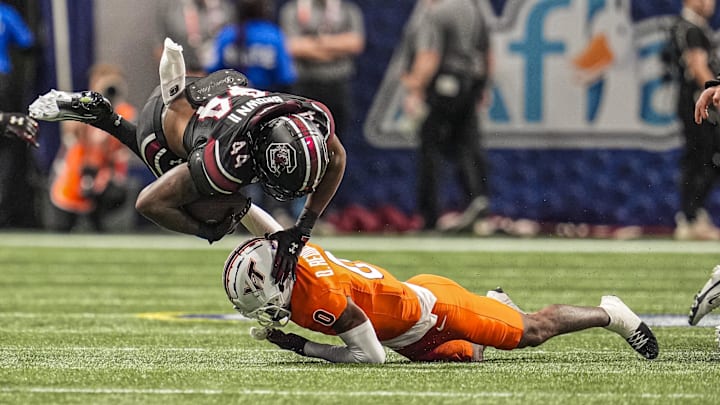 Aug 31, 2025; Atlanta, Georgia, USA; South Carolina Gamecocks tight end Maurice Brown II (44) is tackled by Virginia Tech Hokies safety Quentin Reddish (0) during the first quarter at Mercedes-Benz Stadium. Mandatory Credit: Dale Zanine-Imagn Images