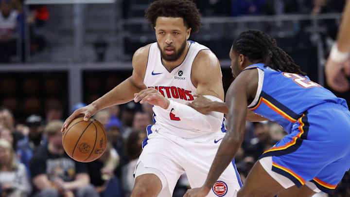 Feb 25, 2026; Detroit, Michigan, USA;  Detroit Pistons guard Cade Cunningham (2) dribbles defended by Oklahoma City Thunder guard Cason Wallace (22) in the first half at Little Caesars Arena.