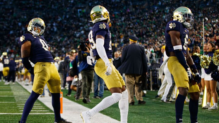 Notre Dame safety Xavier Watts (0), cornerback Christian Gray (29) and safety Adon Shuler (8) celebrate a Watts interception during a NCAA college football game against Virginia at Notre Dame Stadium on Saturday, Nov. 16, 2024, in South Bend.