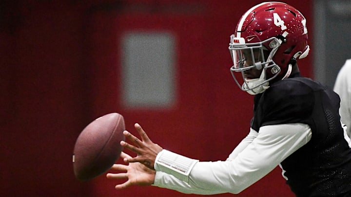 April 9, 2024; Tuscaloosa, Alabama, USA; Alabama quarterback Jalen Milroe (4) takes a snap during practice in the Hank Crisp Indoor Practice Facility at the University of Alabama.