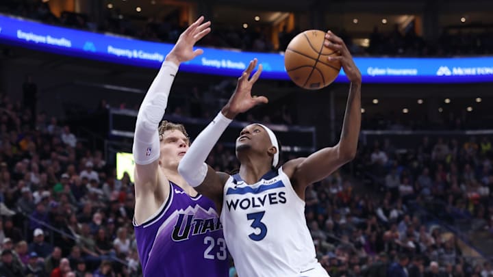 Mar 18, 2024; Salt Lake City, Utah, USA; Minnesota Timberwolves forward Jaden McDaniels (3) goes to the basket against Utah Jazz forward Lauri Markkanen (23) during the fourth quarter at Delta Center. Mandatory Credit: Rob Gray-Imagn Images