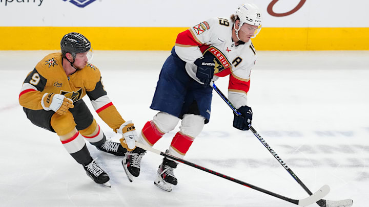 Jan 26, 2025; Las Vegas, Nevada, USA; Florida Panthers left wing Matthew Tkachuk (19) keeps the puck away from Vegas Golden Knights center Jack Eichel (9) during the third period at T-Mobile Arena. Mandatory Credit: Stephen R. Sylvanie-Imagn Images