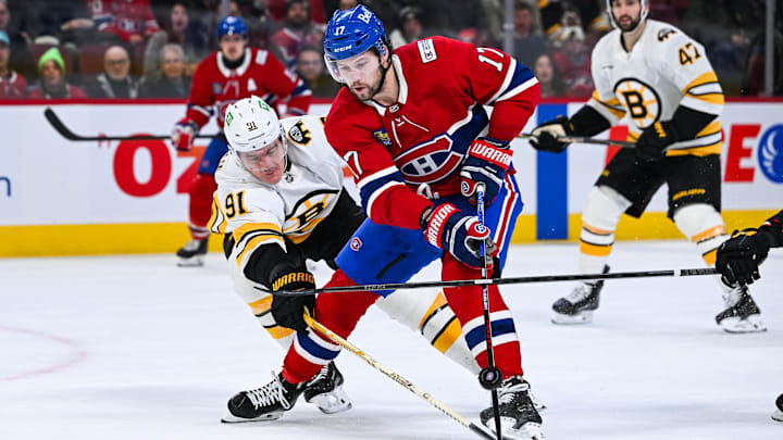 Mar 17, 2026; Montreal, Quebec, CAN; Boston Bruins defenseman Nikita Zadorov (91) defends the puck against Montreal Canadiens right wing Josh Anderson (17) during the second period at Bell Centre. Mandatory Credit: David Kirouac-Imagn Images