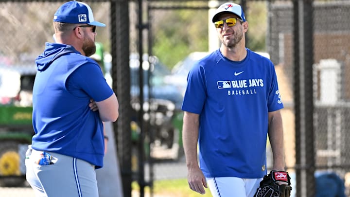 Feb 14, 2025: Toronto Blue Jays manager John Schneider (14) talks with pitcher Max Scherzer (31) during spring training  at Cecil B. Englebert Complex. 