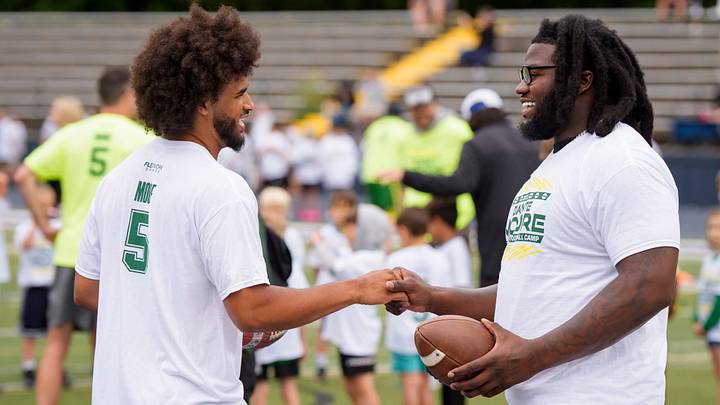 Oregon quarterback Dante Moore, left, greets fellow Duck Bear Alexander during a youth football camp at Marist Catholic High School on June 20, 2026, in Eugene, Oregon.