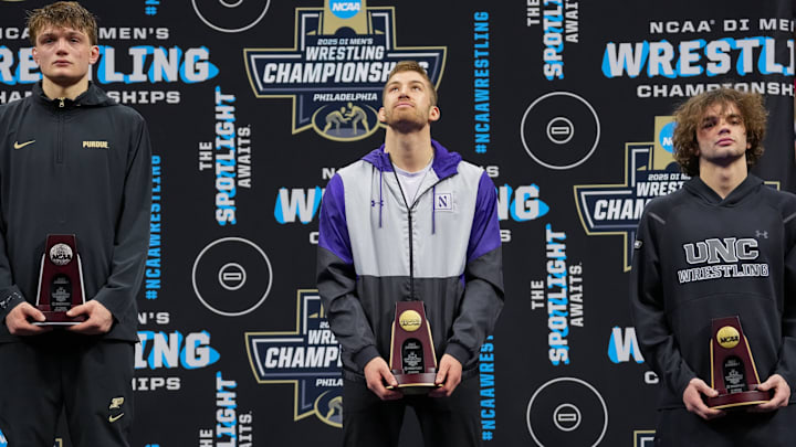 Northwestern wrestler Trevor Chumbley receives his trophy after placing fourth at the NCAA Wrestling Championships on March 22, 2025.