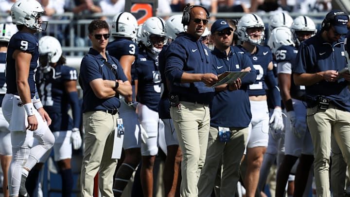 Oct 5, 2024; University Park, Pennsylvania, USA; Penn State Nittany Lions head coach James Franklin (center) looks on from the sideline during the second quarter against the UCLA Bruins at Beaver Stadium. Mandatory Credit: Matthew O'Haren-Imagn Images