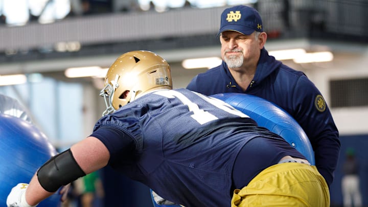 Notre Dame offensive line coach Joe Rudolph, right, runs a drill during a Notre Dame football spring practice at Irish Athletic Center on Wednesday, March 19, 2025, in South Bend.