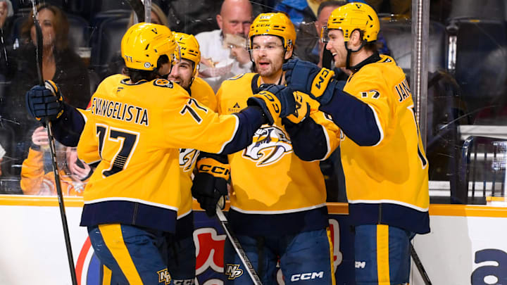 Dec 10, 2024; Nashville, Tennessee, USA;  Nashville Predators center Tommy Novak (82) celebrates his goal with his teammates  against the Calgary Flames during the first period at Bridgestone Arena. Mandatory Credit: Steve Roberts-Imagn Images