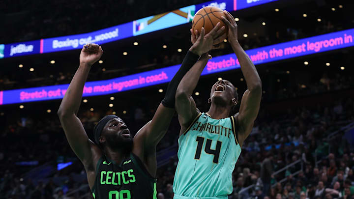 Apr 13, 2025; Boston, Massachusetts, USA; Boston Celtics center Neemias Queta (88) fouls Charlotte Hornets forward Moussa Diabate (14) during the second half at TD Garden. Mandatory Credit: Paul Rutherford-Imagn Images