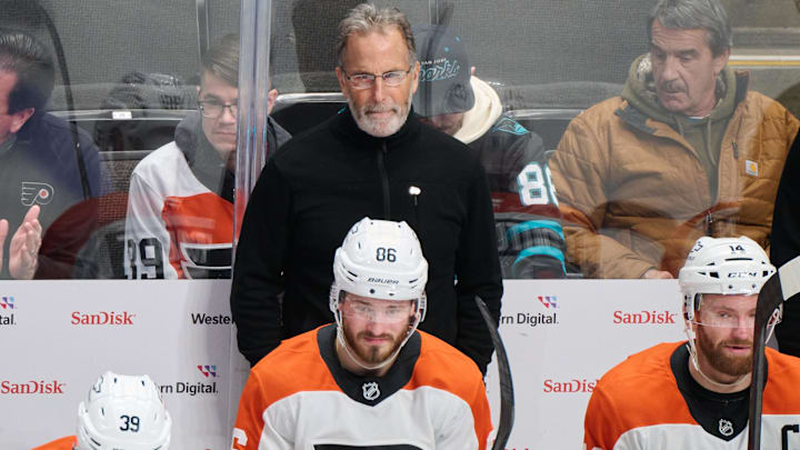 Dec 31, 2024; San Jose, California, USA; Philadelphia Flyers head coach John Tortorella watches game play against the San Jose Sharks with right wing Matvei Michkov (39), left wing Joel Farabee (86) and center Sean Couturier (14) during the third period at SAP Center at San Jose. Mandatory Credit: Robert Edwards-Imagn Images