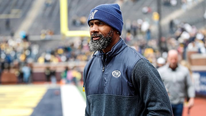 Michigan legend Charles Woodson waves at fans during warmup at the spring game at Michigan Stadium in Ann Arbor.