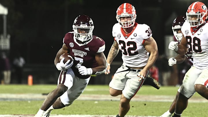 Nov 12, 2022; Starkville, Mississippi, USA;Mississippi State Bulldogs running back Jo'quavious Marks (7) runs the ball against Georgia Bulldogs linebacker Chaz Chambliss (32) during the fourth quarter at Davis Wade Stadium at Scott Field. Mandatory Credit: Matt Bush-Imagn Images