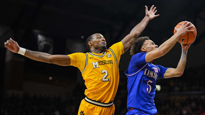 Dec 8, 2024; Columbia, Missouri, USA; Kansas Jayhawks guard Zeke Mayo (5) shoots the ball against Missouri Tigers guard Tamar Bates (2) during the first half at Mizzou Arena. Mandatory Credit: Jay Biggerstaff-Imagn Images