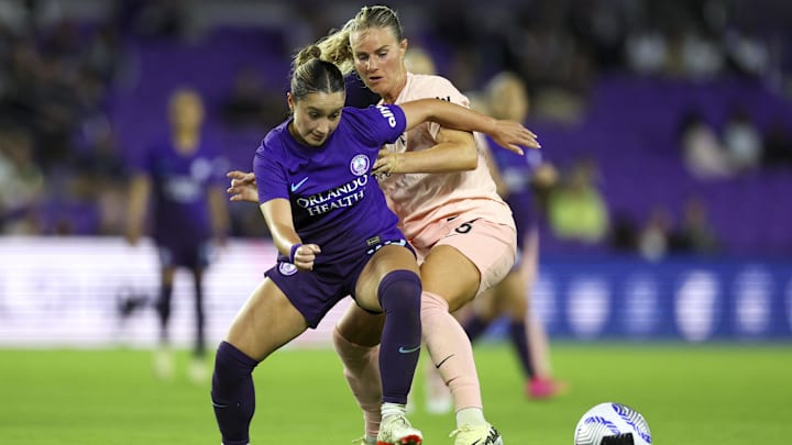 Mar 22, 2024; Orlando, Florida, USA;  Orlando Pride midfielder Ally Lemos (30) and Angel City FC midfielder Amandine Henry (26) battle for the ball in the second half at Inter&Co Stadium. Mandatory Credit: Nathan Ray Seebeck-USA TODAY Sports