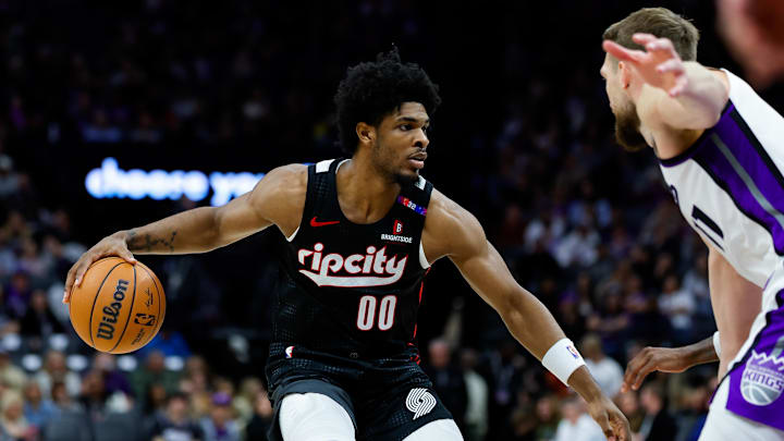 Mar 27, 2025; Sacramento, California, USA; Portland Trail Blazers guard Scoot Henderson (00) dribbles against Sacramento Kings forward Domantas Sabonis (11) during the third quarter at Golden 1 Center. Mandatory Credit: Sergio Estrada-Imagn Images Mar 27, 2025; Sacramento, California, USA; Portland Trail Blazers guard Scoot Henderson (00) dribbles against Sacramento Kings forward Domantas Sabonis (11) during the third quarter at Golden 1 Center. Mandatory Credit: Sergio Estrada-Imagn Images