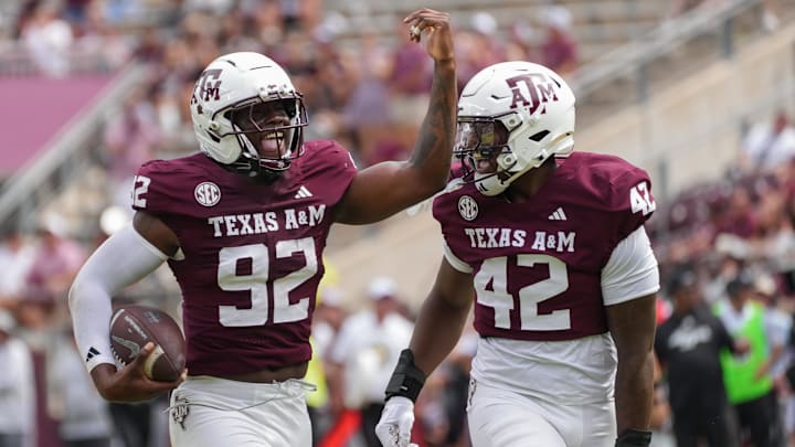 Sep 6, 2025; College Station, Texas, USA; Texas A&M Aggies defensive end Sam M'Pemba (92) and Texas A&M Aggies defensive end Kendall Jackson (42) celebrate after a recovered fumble during the second half against the Utah State Aggies at Kyle Field. Mandatory Credit: Sean Thomas-Imagn Images