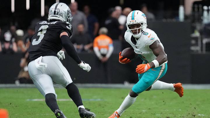 Miami Dolphins wide receiver Malik Washington moves with the ball while defended by Las Vegas Raiders cornerback Taron Johnson (3) in the second quarter at Allegiant Stadium. Miami Dolphins wide receiver Malik Washington moves with the ball while defended by Las Vegas Raiders cornerback Taron Johnson (3) in the second quarter at Allegiant Stadium.