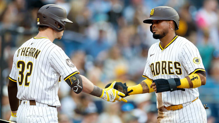 Sep 13, 2025; San Diego, California, USA; San Diego Padres second baseman Luis Arraez (4) first baseman Ryan O'Hearn (32) after scoring a run during the first inning against the Colorado Rockies at Petco Park. Mandatory Credit: David Frerker-Imagn Images