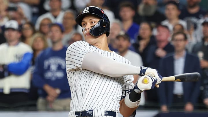 Oct 7, 2025; Bronx, New York, USA; New York Yankees outfielder Aaron Judge (99) hits a three-run home run in the fourth inning against the Toronto Blue Jays during game three of the ALDS round for the 2025 MLB playoffs at Yankee Stadium. Mandatory Credit: Vincent Carchietta-Imagn Images