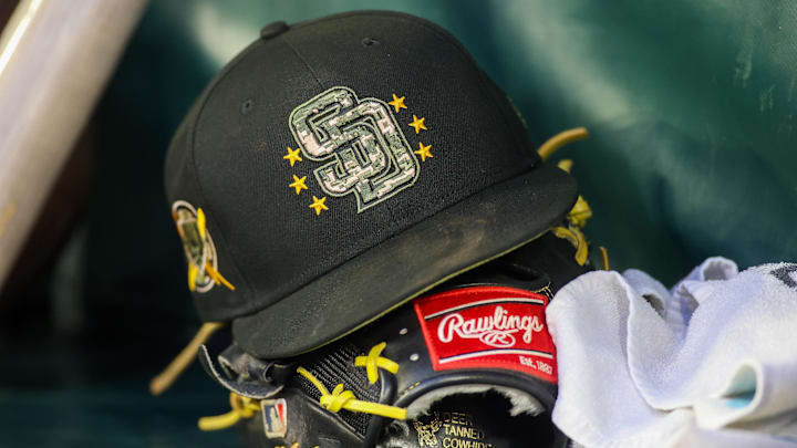 May 17, 2024; Atlanta, Georgia, USA; A detailed view of a San Diego Padres hat and glove on the bench against the Atlanta Braves in the third inning at Truist Park. Mandatory Credit: Brett Davis-Imagn Images May 17, 2024; Atlanta, Georgia, USA; A detailed view of a San Diego Padres hat and glove on the bench against the Atlanta Braves in the third inning at Truist Park. Mandatory Credit: Brett Davis-Imagn Images