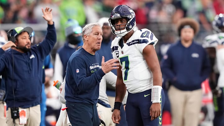 Seattle Seahawks head coach Pete Carroll talks with quarterback Geno Smith against the Arizona Cardinals.