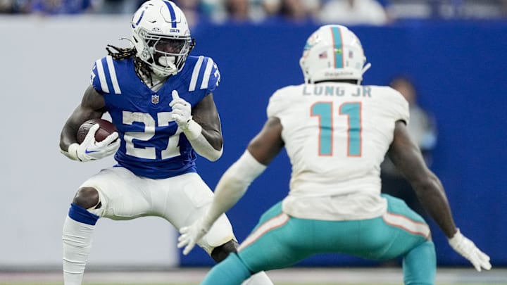 Indianapolis Colts running back Trey Sermon (27) looks to rush past Miami Dolphins linebacker David Long Jr. (11) during a game against the Miami Dolphins