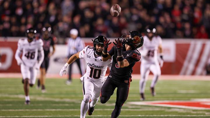 Nov 1, 2025; Salt Lake City, Utah, USA; Utah Utes wide receiver Ryan Davis (9) makes a catch over Cincinnati Bearcats safety Tayden Barnes (10) during the second quarter at Rice-Eccles Stadium. Mandatory Credit: Rob Gray-Imagn Images
