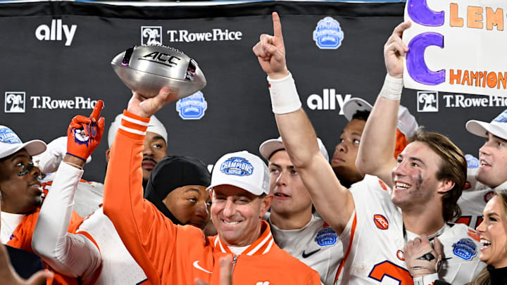 Dec 7, 2024; Charlotte, NC, USA; Clemson Tigers head coach Dabo Swinney, quarterback Cade Klubnik (2) and teammates celebrate after winning the 2024 ACC Championship game against the Southern Methodist Mustangs at Bank of America Stadium.