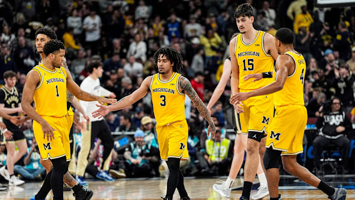 Michigan guard Elliot Cadeau shakes hands with teammates