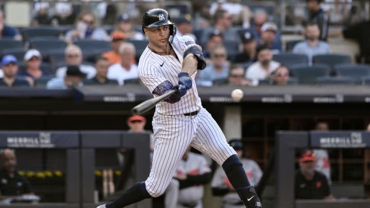 Jun 20, 2024; Bronx, New York, USA; New York Yankees designated hitter Giancarlo Stanton (27) hits a single during the fifth inning against the Baltimore Orioles at Yankee Stadium. Mandatory Credit: John Jones-USA TODAY Sports Jun 20, 2024; Bronx, New York, USA; New York Yankees designated hitter Giancarlo Stanton (27) hits a single during the fifth inning against the Baltimore Orioles at Yankee Stadium. Mandatory Credit: John Jones-USA TODAY Sports