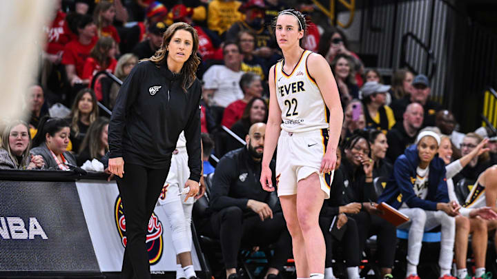 May 4, 2025; Iowa City, IA, USA; Indiana Fever guard Caitlin Clark (22) looks on with head coach Stephanie White during the third quarter against the Brazil National Team at Carver-Haweye Arena. Mandatory Credit: Jeffrey Becker-Imagn Images