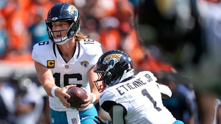 Jacksonville Jaguars wide receiver Chandler Brayboy (15) hands off to Jacksonville Jaguars running back Travis Etienne Jr. (1) in the first quarter of the NFL Week 2 game between the Cincinnati Bengals and the Jacksonville Jaguars at Paycor Stadium in downtown Cincinnati on Sunday, Sept. 14, 2025. 