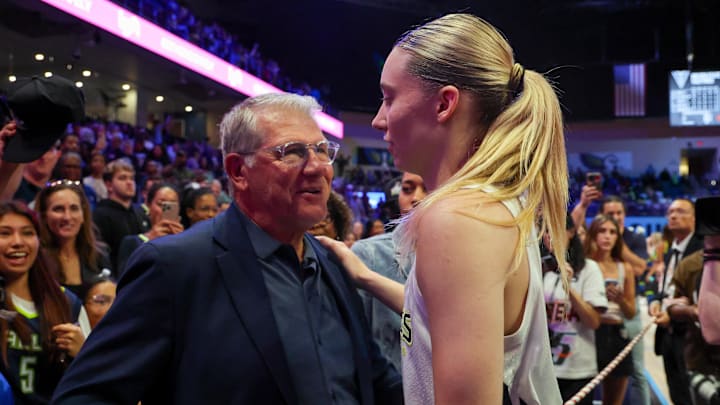 Jun 17, 2025; Arlington, Texas, USA;  University of Connecticut head coach Geno Auriemma speaks with Dallas Wings guard Paige Bueckers (5) after the game against the Golden State Valkyries at College Park Center. Mandatory Credit: Kevin Jairaj-Imagn Images