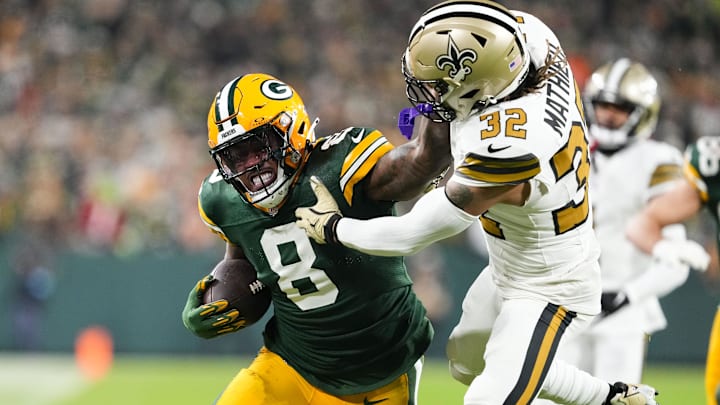 Green Bay Packers running back Josh Jacobs (8) stiff-arms New Orleans Saints safety Tyrann Mathieu.