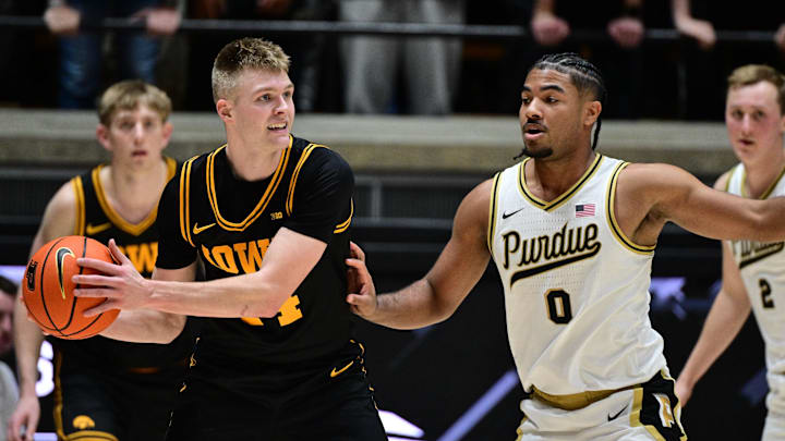 Jan 14, 2026; West Lafayette, Indiana, USA; Iowa Hawkeyes guard Bennett Stirtz (14) looks for an open teammate around Purdue Boilermakers guard C.J Cox (0) during the second half at Mackey Arena. Mandatory Credit: Marc Lebryk-Imagn Images Jan 14, 2026; West Lafayette, Indiana, USA; Iowa Hawkeyes guard Bennett Stirtz (14) looks for an open teammate around Purdue Boilermakers guard C.J Cox (0) during the second half at Mackey Arena. Mandatory Credit: Marc Lebryk-Imagn Images