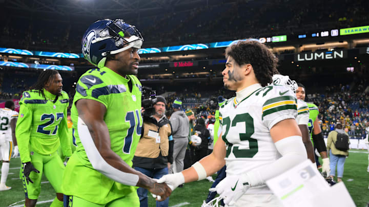 Dec 15, 2024; Seattle, Washington, USA; Seattle Seahawks wide receiver DK Metcalf (14) and Green Bay Packers safety Evan Williams (33) shake hands after the game at Lumen Field. Mandatory Credit: Steven Bisig-Imagn Images
