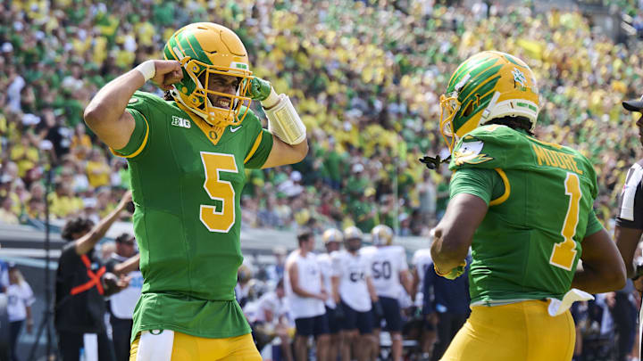 Aug 30, 2025; Eugene, Oregon, USA; Oregon Ducks quarterback Dante Moore (5) celebrates with wide receiver Dakorien Moore (1) after a touchdown scored by wide receiver Gary Bryant Jr. (2) during the second half against the Montana State Bobcats at Autzen Stadium. Mandatory Credit: Troy Wayrynen-Imagn Images
